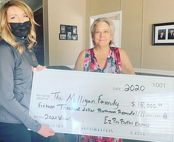 family holds giant prize after winning bathroom giveaway